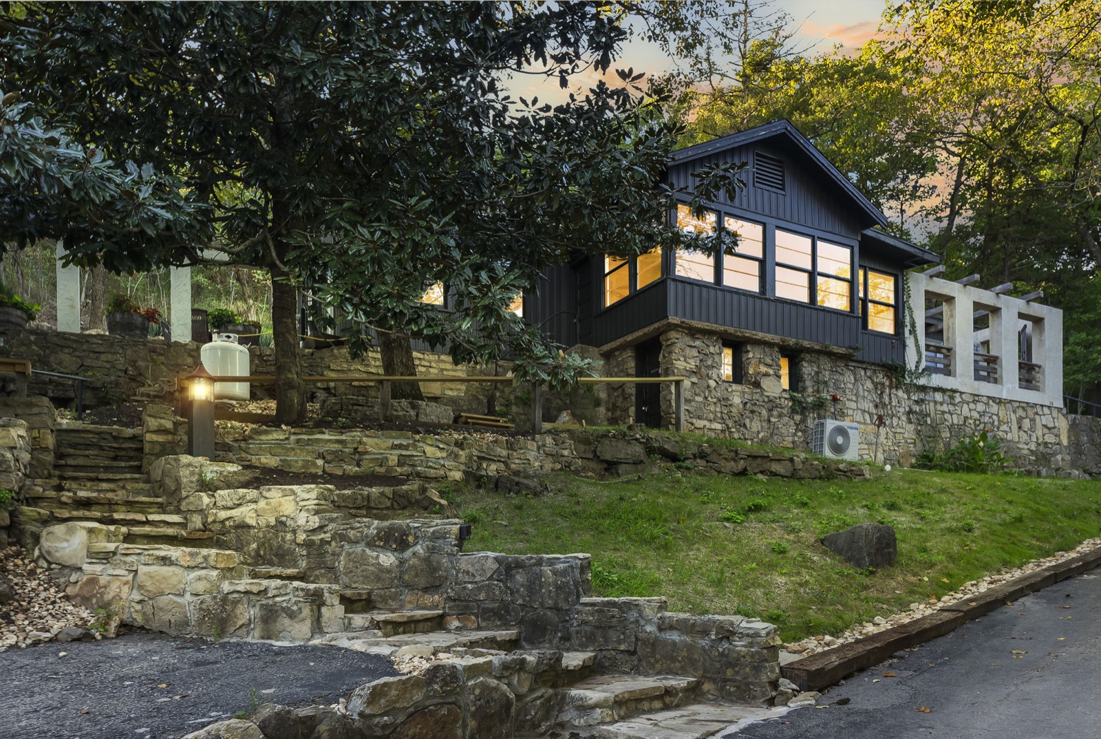 Dusk exterior of stone-and-wood Branson rental